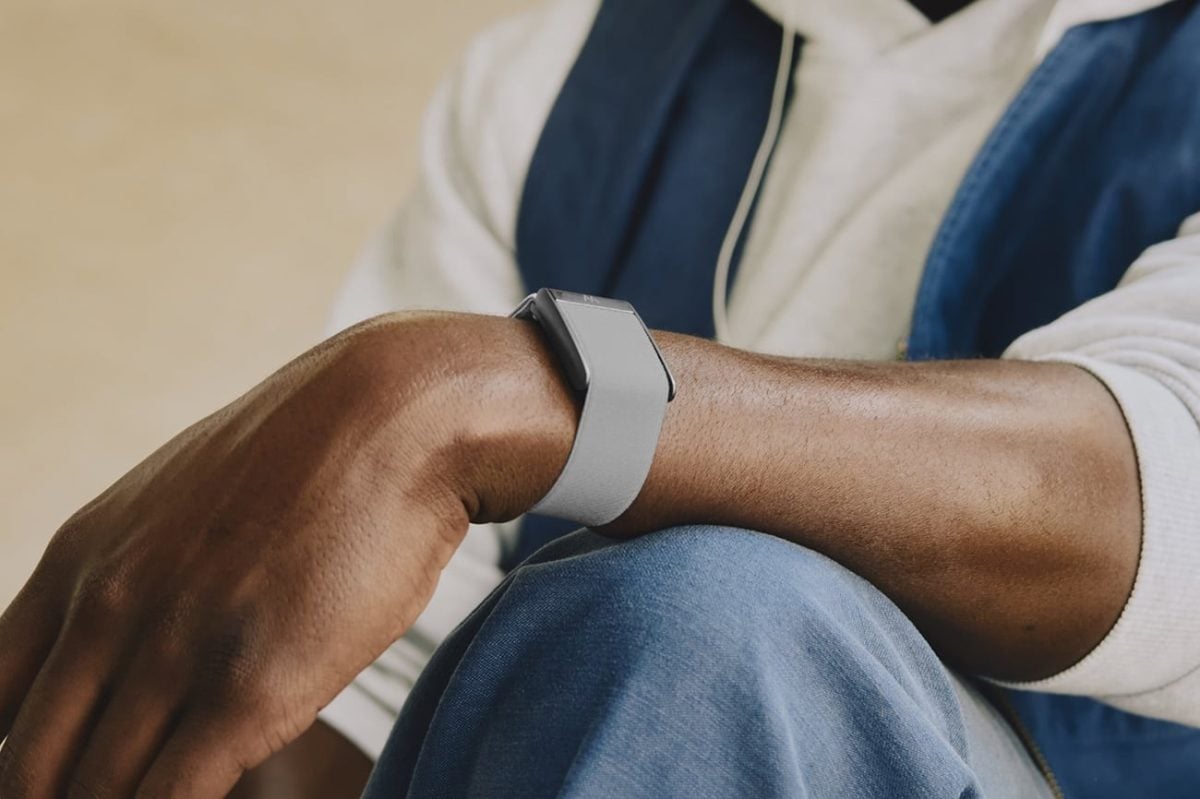 手首に装着するグレーのWhoopブレスレット。.